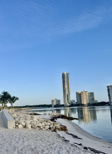 A governess on Key Biscayne with a child on the island at golden hour